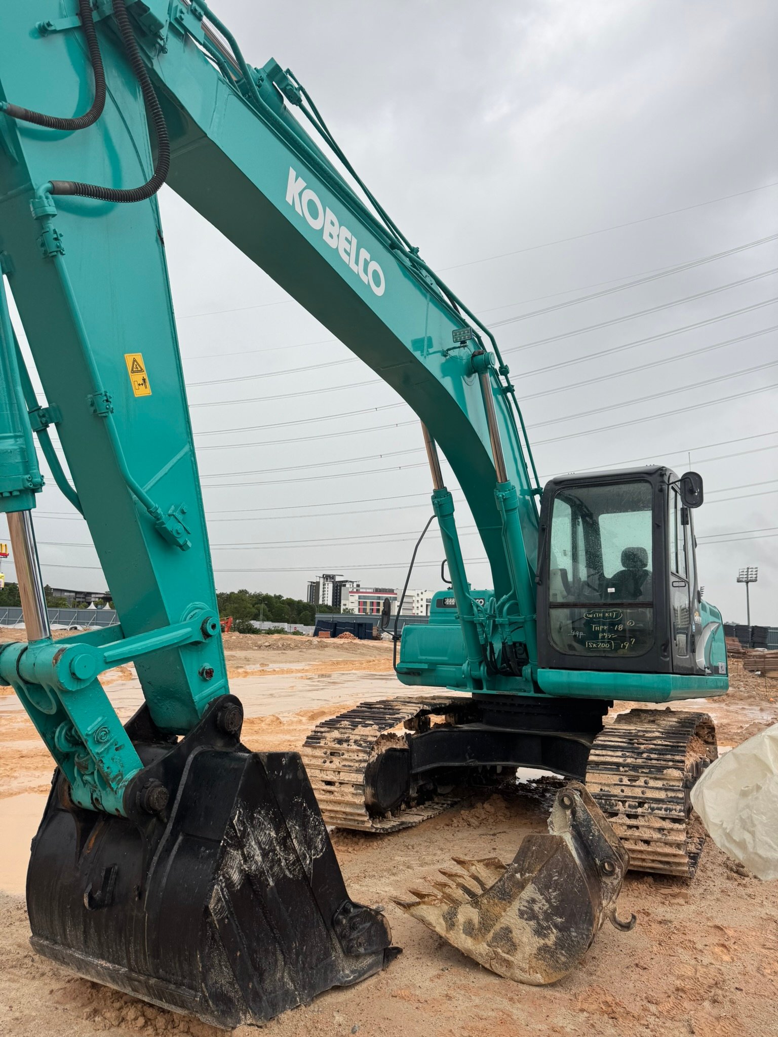 Kobelco SK200 excavator rental in Johor Unit D working on construction site